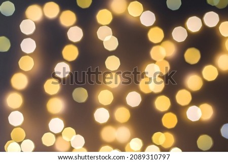 Festive blurred background of orange round lights on a dark backdrop. The perfect concept for a close-up New Year's design.