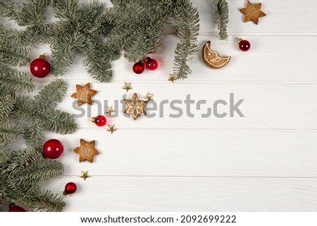 Fir branches, Christmas decorations and cookies on an white wooden background. Christmas background with free space for text