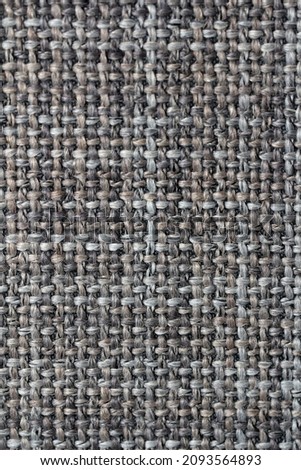 the texture of the coarse fabric is matting due to the interweaving of large threads of different colors