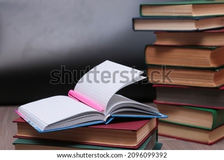 notebook with pen on a background of books, selective focus  