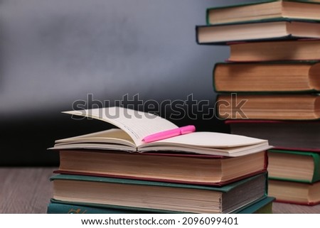notebook with pen on a background of books, selective focus  