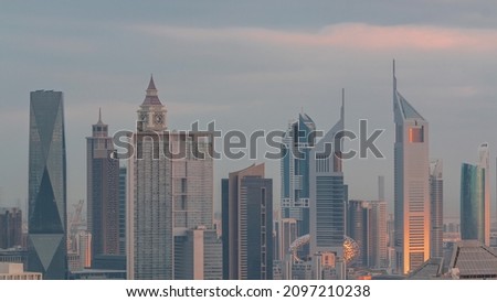 Rows of skyscrapers in financial district of Dubai aerial morning timelapse during sunrise. Panoramic view to many towers from Business bay district