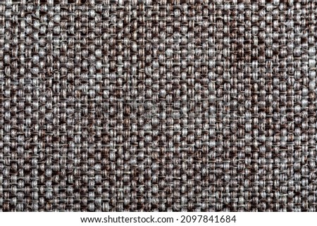 Brown fabric texture. Furniture upholstery textiles. Embossed pattern. Woven fibers. The material is soft touch. Minimalism concept. High detail macro photography for backgrounds or wallpapers.