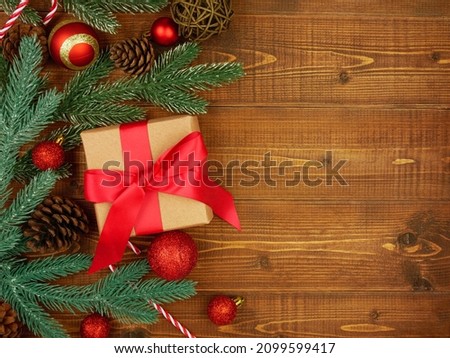 Flat lay,top viewChristmas ornaments and gift box on brown wooden background with copy space