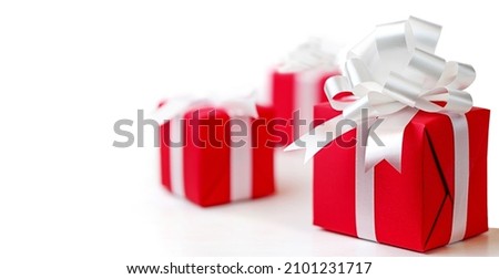 Red gift boxes with white bow on a white background.
