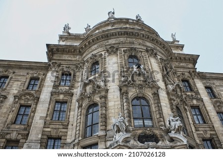 The facade of building on street of Munich. Selective focus.