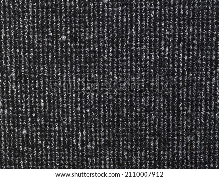 Texture of dark knitted fabric. Black texture fabric background