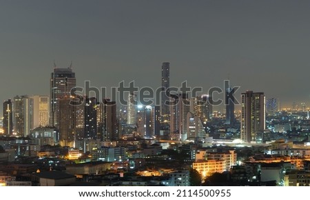 Aerial view of Sathorn, Bangkok Downtown skyline. Financial district and business centers in smart urban city town in Asia. Skyscraper and high-rise buildings at night.