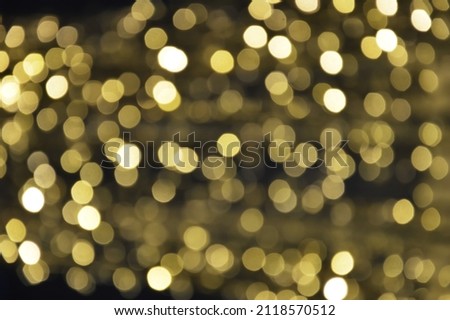the bokeh lights are yellow. Festive shiny background for celebrating Merry Christmas and Happy New Year. decoration of the city for winter holidays.