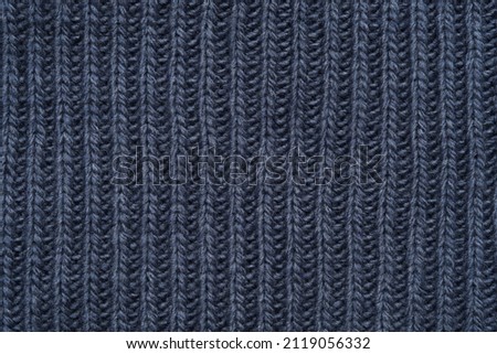 Blue knitted texture of a scarf or a warm sweater.