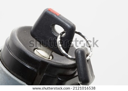 Car ignition lock with keys on a white background. Close-up.