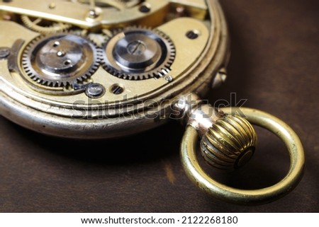Old pocket watch. Ancient gears on the leather background. 