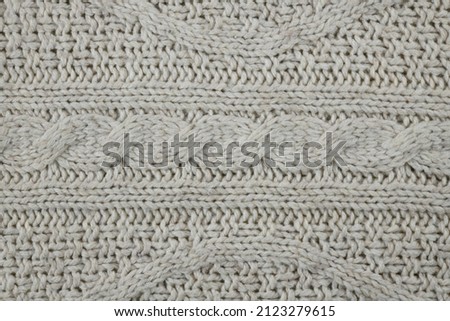 Texture of a white wool fabric arranged horizontally as a background.