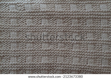 
texture of a knitted light plaid