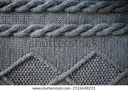 Warm knitted gray blanket. Soft, warm, handmade plaid. Texture for background or illustrations. Copy space, flat lay, top view