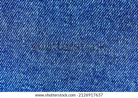 Blue hipster jeans material. Denim Cloth texture background. Natural fabrics textile.