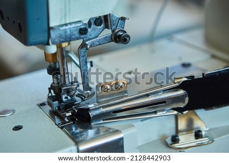 Industrial sewing production or atelier. Sewing machines for creating clothes. Fashion and beauty.