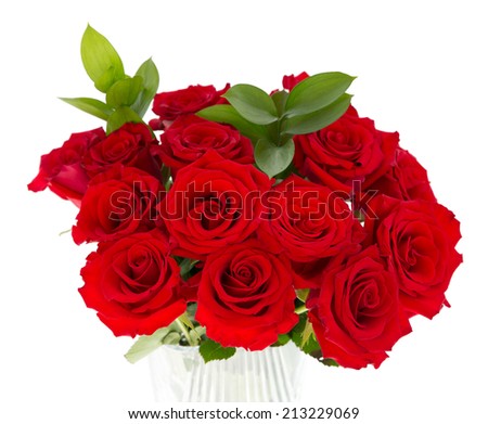 A bouquet of red roses in a glass vase isolated on a white background. 