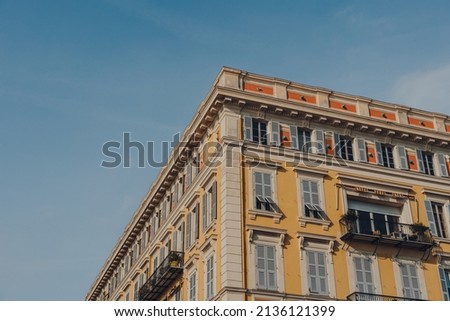 Low angle view of a residential building in Nice, France, against the blue sky.
