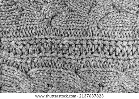 Warm knitting texture in black and white. Background and texture for design.