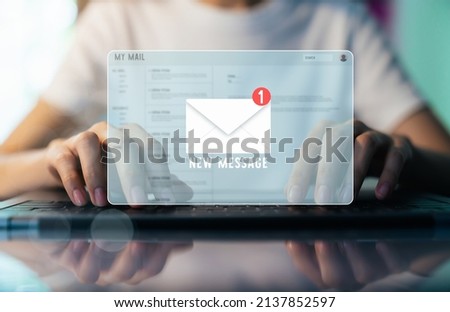 Woman had using laptop show email screen on application mobile in the office.