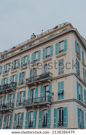 Low angle view of a traditional residential building in Nice, France, against the blue sky.