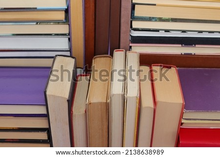 Stack of books on violet background