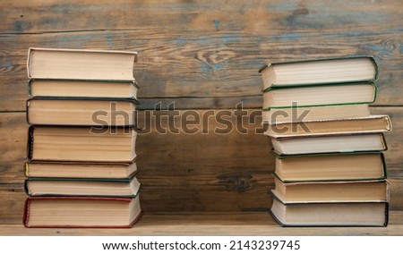 Many stack books on wooden background. Back to school with copy space.