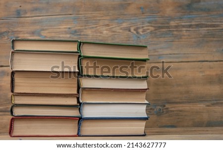 Many stack books on wooden background. Back to school with copy space.
