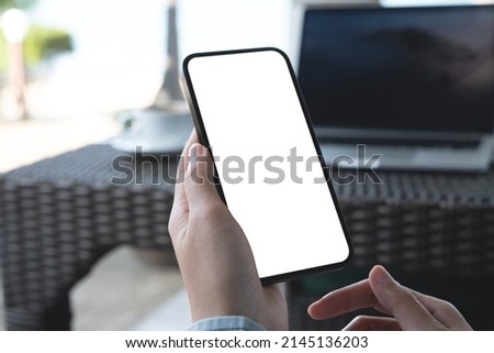 Cell phone blank white screen mockup. Woman hands holding, using mobile phone at coffee shop, template for advertisement. Work people contact, business marketing, technology