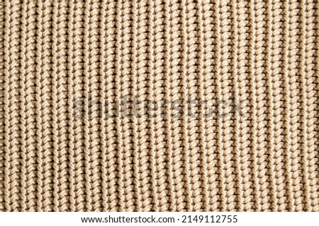 Knitted fabric structure.  Handmade fabric, cotton thread. Sweater fragment, repeating pattern.