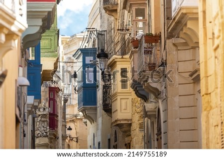 View of a street with buildings with traditional maltese bay windows in the city of Mdina, Malta.