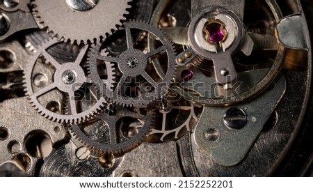 Clockwork, hand wind up watch mechanism - close up macro, showing mechanical movements - gears, ruby jewels and mainspring
