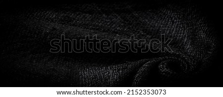 Dense woolen fabric, thick black threads. Scarf. Play with texture for an eye-catching look with this black wool-look acrylic twill.