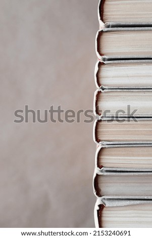 Stack of books on a blurred craft background, book spine, space for text, selective focus
