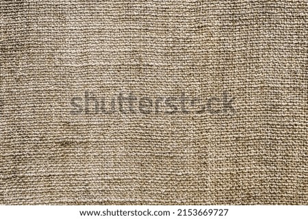 Background, texture of a crumbly fabric woven in spots of burlap close-up. Photography, abstraction.