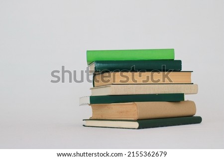 Green books on white background