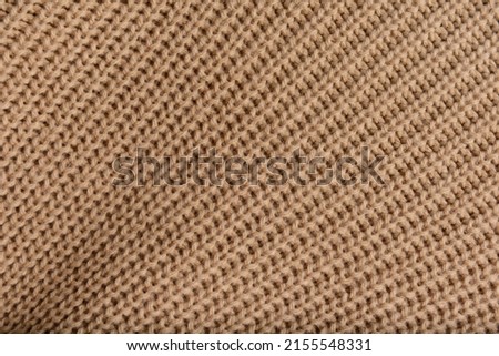 Closeup texture of brown knitted sweater.