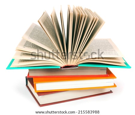 The open book on a pile of multi-coloured books. On a white background.