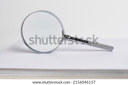 Magnifier, magnifying glass lens for analysis, proofread, checking, investigating. High quality photo