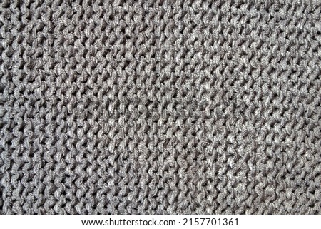 a piece of gray fabric similar to chain mail