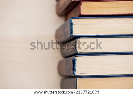 A stack of books is on the table, top view. copy space