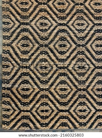 Handmade geometric natural fiber area rug.