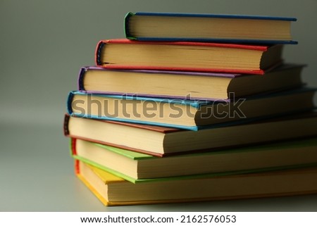 Close up of a book stack against grey background