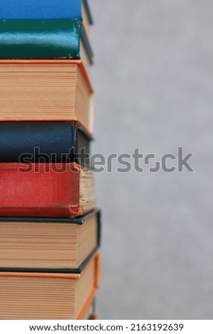 Stack of books on grey background