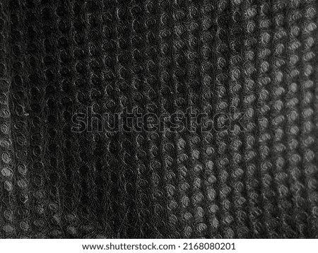 Selective focus.Close-up black bag blanket background and texture.