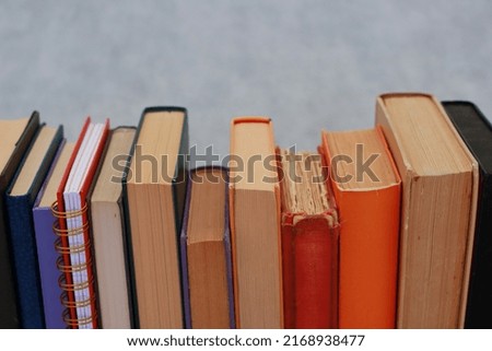 Stack of books on grey background
