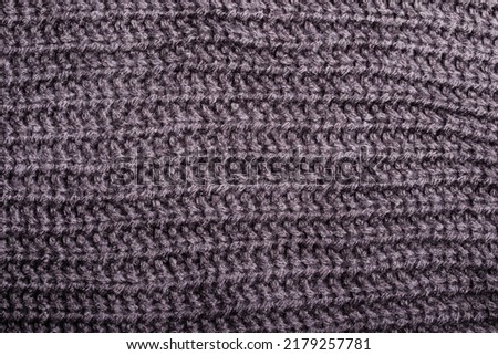 Black and gray knitted silk thread pattern for background.