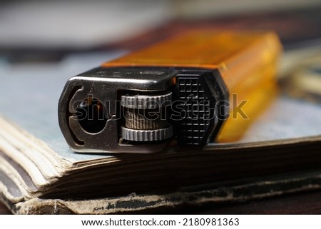 selective focus of gas lighter and broken book