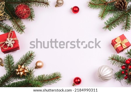 Christmas background, fir branches, gift boxes, red balls and Christmas decorations on white background. Top view, flat lay, copy space.